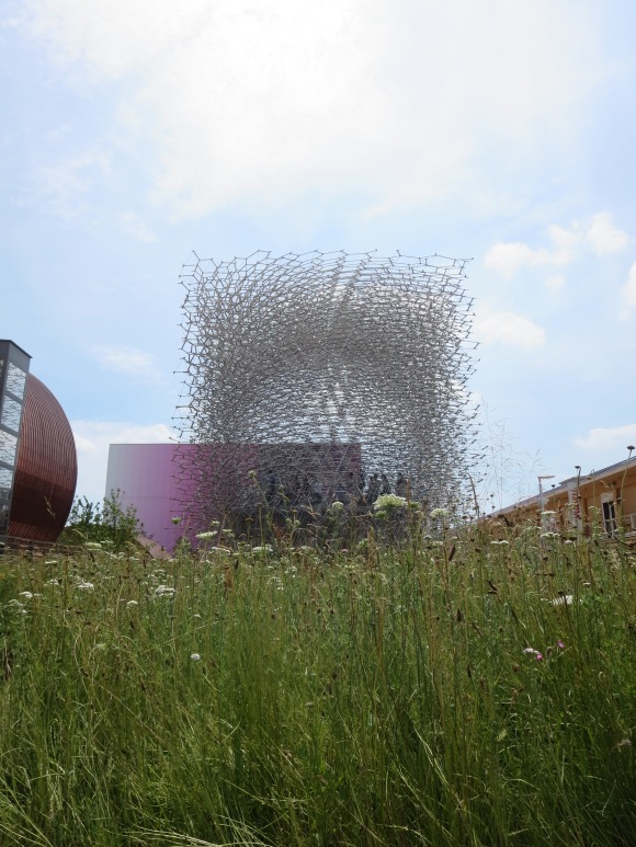 The UK beehive pavilion. The pavilion is connected to an actual beehive in Nottingham: In the pavilion, speakers and LEDs generate noise to reflect the real-time activity of bees in the actual hive.